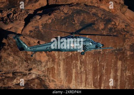 An HH-60W Jolly Green II flies over the Valley of Fire as part of a 53rd Wing Civic Leader flight from Nellis Air Force Base, Nevada, Dec. 12, 2023. T Stock Photo