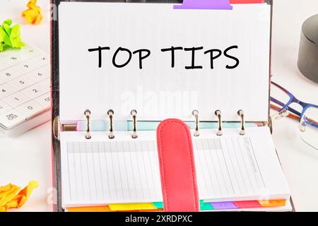 Top tips. Inscription TOP TIPS word in an open notebook on a white background Stock Photo