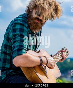 Man plays the guitar. Nature, sky background. Guitars acoustic. Male musician playing guitar, music instrument. Man's hands playing acoustic guitar Stock Photo