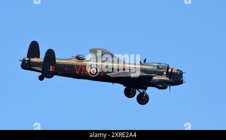 Vintage Avro Lancaster world war 2 bomber with wheels down in flight. Stock Photo