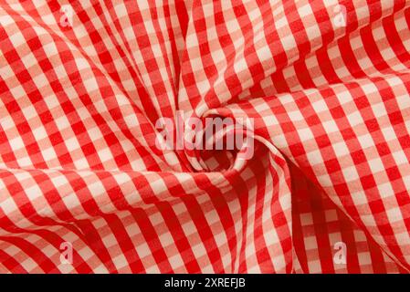 Twisted piece of red checkered fabric. Checkered fabric. Textile. Material Stock Photo