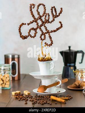 real coffee bean sign over splashing coffee in a balanced cup Stock Photo