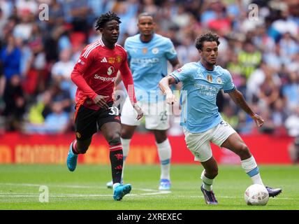 Manchester City's Oscar Bobb in action against Manchester United's Kobbie Mainoo during the FA Community Shield match at Wembley Stadium, London. Picture date: Saturday August 10, 2024. Stock Photo