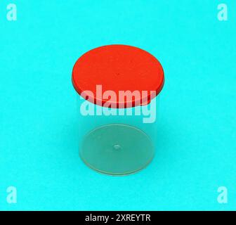 Empty plastic container with red lid used for medical samples Stock Photo