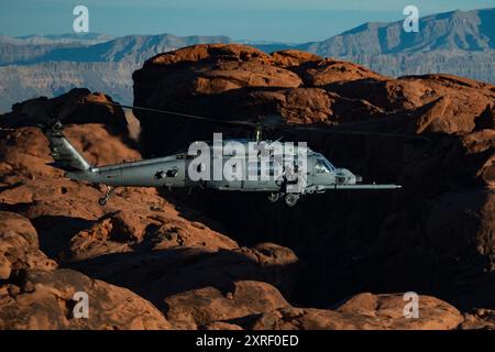 An HH-60W Jolly Green II flies over the Valley of Fire as part of a 53rd Wing Civic Leader flight from Nellis Air Force Base, Nevada, Dec. 12, 2023. T Stock Photo