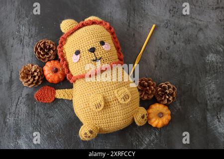 Crocheted toy close up photo. Colorful hand made rug dolls against dark background with space for text. Cute autumn gift ideas. Hobby and leisure Stock Photo