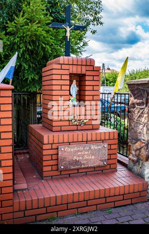 Small chapel (Shrine) on the side of a street in Opoczno, Poland. Religious site. Catholic. Urban. Pilgrimage. Stock Photo