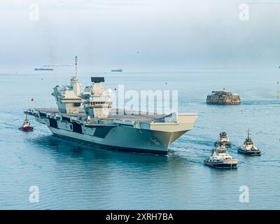 HMS Queen Elizabeth Returns to Portsmouth after repairs in Rosyth, Scotland which cause her to miss Steadfast Defender 2024 Stock Photo