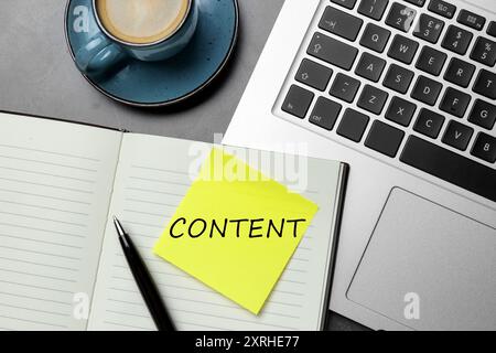 Note with word Content written in notebook on table. Workplace, top view Stock Photo