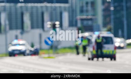 Two police cars and police officers in action. Blurred police scene. Czech police stock photo. Stock Photo