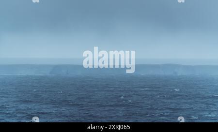 A23a Largest Iceberg in the World Antarctica Moody Clouds Fog and Dark Ocean. Ice Shelf Climate Change View From Scenic Cruise Stock Photo