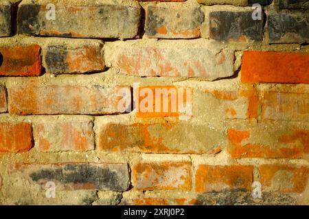 A close-up view of a textured brick wall featuring various colors and patterns. Stock Photo