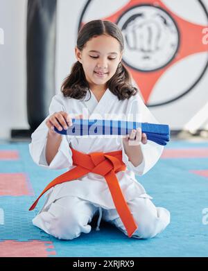 Martial arts, belt and girl in studio for fitness, training and fight with discipline, development and respect. Student, kung fu and practice in dojo Stock Photo