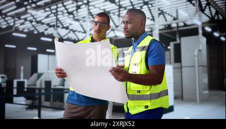 Factory Worker Osha Safety Inspection Using Blueprints Stock Photo