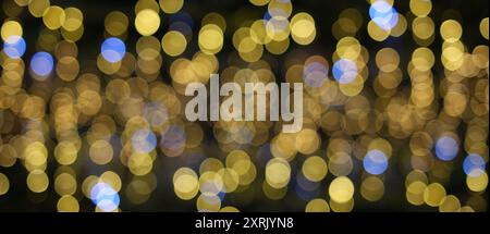 Festive Bokeh Lights: Abstract Background of Blurred Golden and Blue Circular Lights Stock Photo