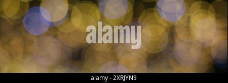 Festive Bokeh Lights: Abstract Background of Blurred Golden and Blue Circular Lights Stock Photo