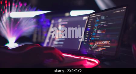 Program code on a computer monitor with fiber optic background. Internet and technology concept. Stock Photo