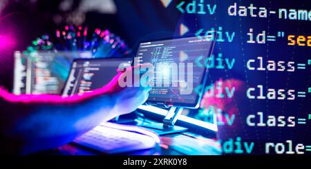 Programmer manually working with program code on a computer at night in a data center  and technology concept. Stock Photo