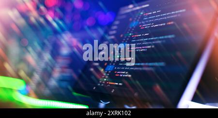 Program code on a computer monitor with fiber optic background. Internet and technology concept. Stock Photo