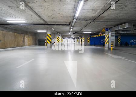 Empty underground parking lot. Exit road. Stock Photo