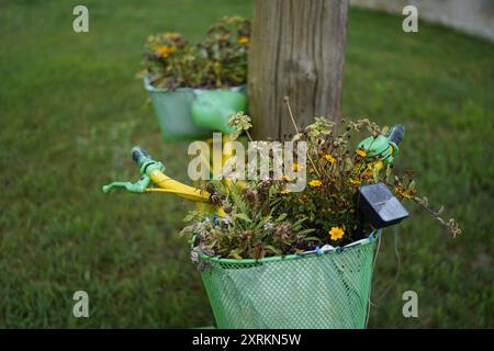 Image showing a yellow and green painted bicycle on Havel cycle path near Goetllin district in Germany.This painted bicycle is used as a marker. Stock Photo