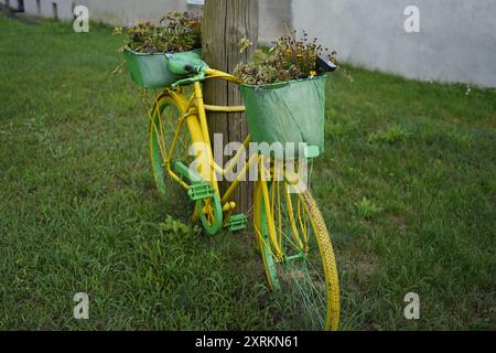 Image showing a yellow and green painted bicycle on Havel path way near Goettlin district in Germany..This painted bicycle is used as a marker. Stock Photo