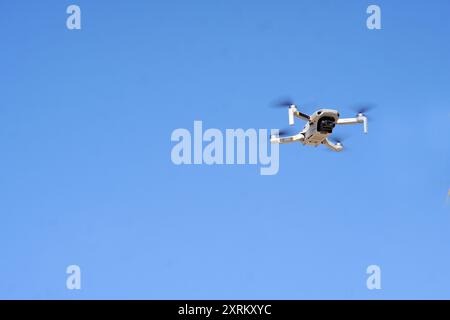 drone hovering in the blue sky air Stock Photo
