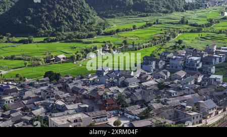 (240811) -- ANSHUN, Aug. 11, 2024 (Xinhua) -- An aerial drone photo taken on July 24, 2024 shows Baojiatun Village in Xixiu District of Anshun City, southwest China's Guizhou Province.  Tunpu means 'fort' in Chinese, referring to the complex of residential buildings in villages of Anshun built in the style of fortress for resisting the enemy's attacks in ancient times.    In the Ming Dynasty (1368-1644), some troops were sent to Anshun, where they built villages and cultivated land for farming. Their descendants have lived there over generations with their original living customs preserved. Th Stock Photo