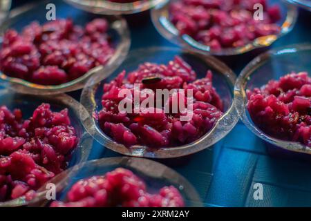 Black fermented glutinous rice in a plastic cup. 'Tape' is a traditional Indonesian fermented food made from glutinous rice or cassava. Stock Photo