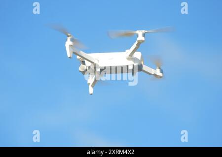 drone hovering in the blue sky air Stock Photo