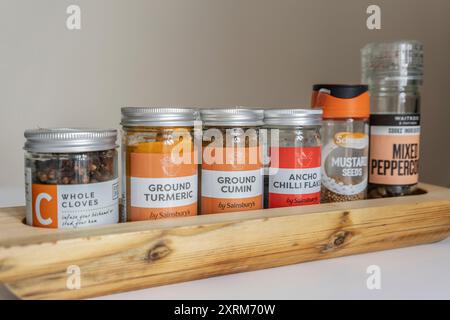Spice rack/ spice tray with a variety of spices in small jars Stock Photo