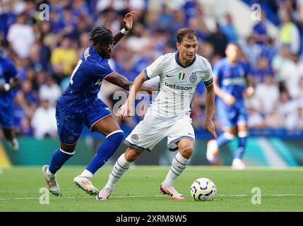 Inter Milan's Nicolo Barella battles for the ball against Chelsea's Noni Madueke during the pre-season friendly match at Stamford Bridge, London. Picture date: Sunday August 11, 2024. Stock Photo