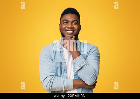 Portrait of handsome black guy touching his beard Stock Photo