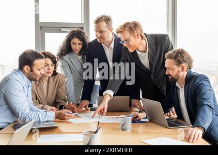 Business Professionals Collaborating on Project During Meeting Stock Photo