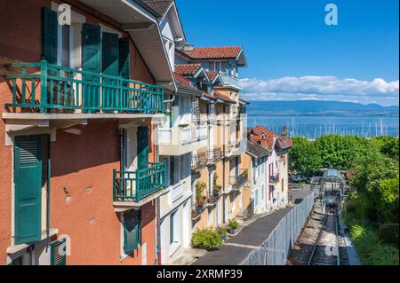 View of the tracks  of the funicular of Thonon-les-Bains with bording houses and Lake Geneva at the horizont Stock Photo