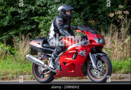 Potterspury,Northants,UK - Aug 11th 2024: 1999 red Suzuki GSXR600 motorcycle travelling on a British road Stock Photo