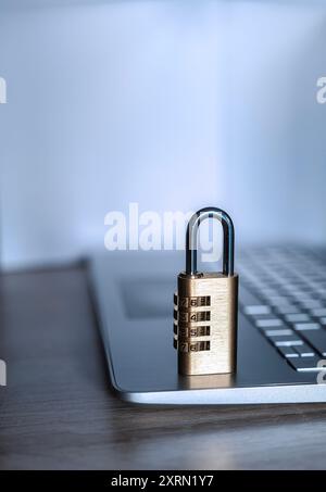Close-up of a closed number padlock on top of a laptop, security, antivirus, protection, anti-theft concept Stock Photo
