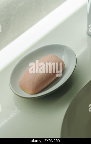 pink soap in ceramic bowl in bathroom . High quality photo Stock Photo