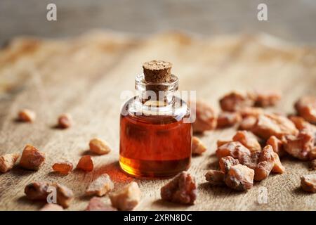 A transparent bottle of aromatherapy essential oil with styrax or benzoin resin Stock Photo