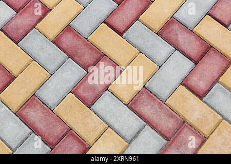 Red and yellow Brick paving stones on a sidewalk or pavement. Top view, copy space Stock Photo