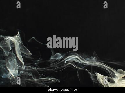 Abstract white smoke texture moves on black background Plume of smoke wave design wallpaper. Design element. Abstract texture Stock Photo