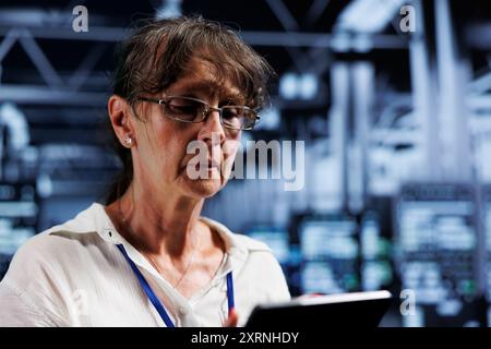 Precise serviceman in high tech business providing computing resources needed for AI to process extensive datasets for training. Server equipment storing datasets used for machine learning, close up Stock Photo