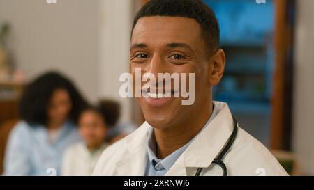 Close up happy confident African American man doctor medical worker looking at camera toothy dental smile professional specialist health face medicine Stock Photo