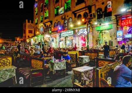 Busy Evening activity in the vicinity of the Elzahraa Cafe and Restaurant across the street from the Mosque of Imam Hussein in Cairo Stock Photo