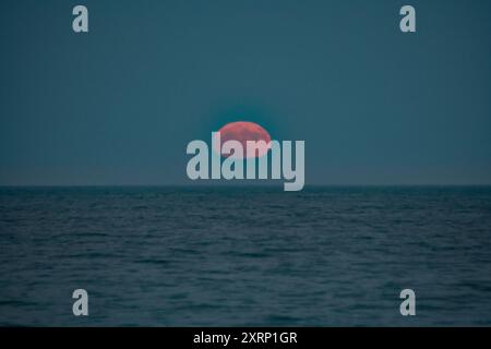 Full moon rises over the Atlantic Ocean Stock Photo