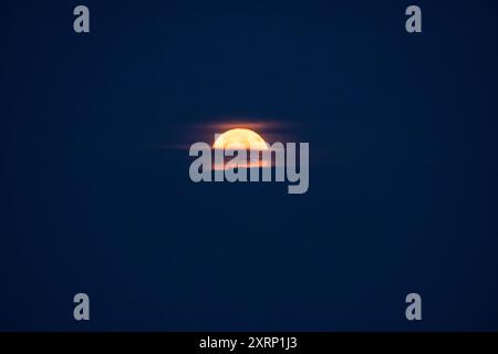 Full moon rises over the Atlantic Ocean Stock Photo
