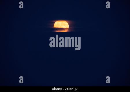 Full moon rises over the Atlantic Ocean Stock Photo