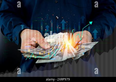 Hand holding a paycheck with dollar signs. Businessman hands counting dollars close up, calculating paper bills. Investment theme stockmarket and fina Stock Photo