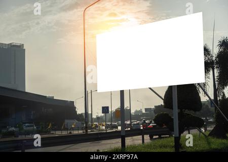 Large city blank billboard with white advertising space for blank mockup advertisements Concept Advertising Billboards Cityscape Mockup Marketing.  Bl Stock Photo