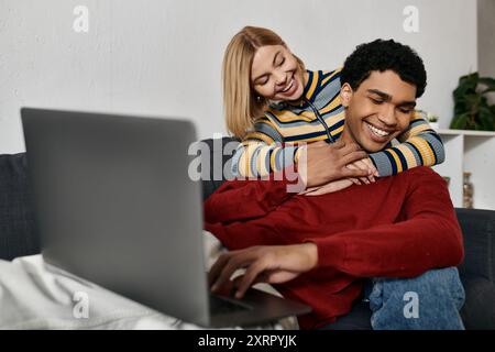 A multicultural couple shares a loving moment in their modern apartment, enjoying a relaxing evening together. Stock Photo